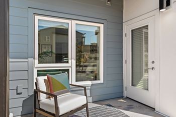 a porch with a chair and a window at Gage On Sixth, Washington, 98465